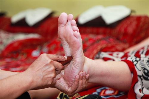 Foot Massage by hand with stick